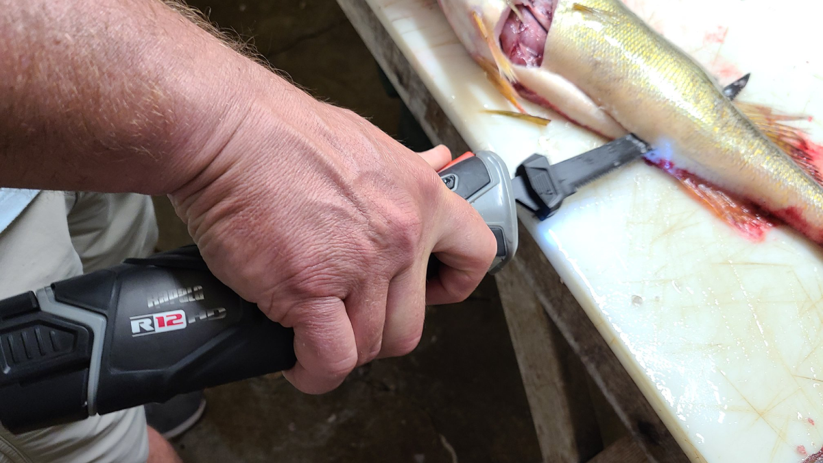Man using Rapala Heavy Duty Electric Fillet Knife to fillet fish