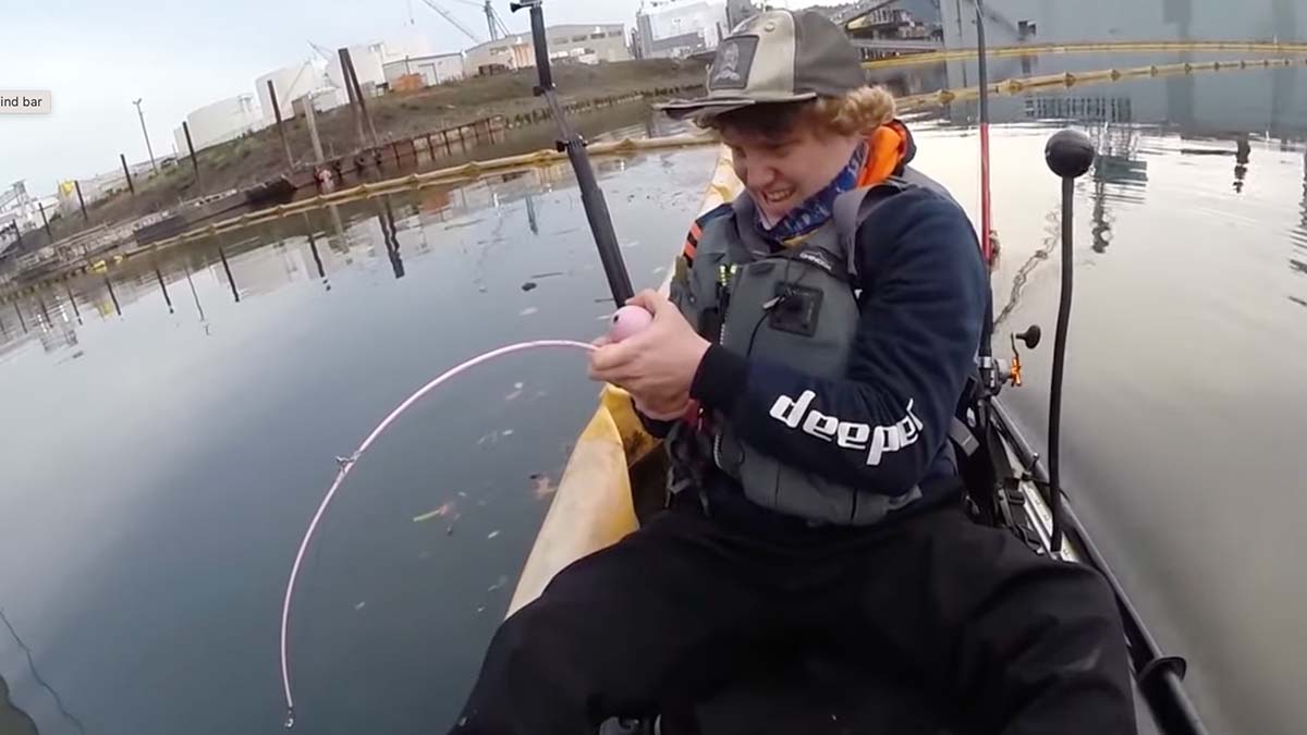 boy fights sturgeon on kayak with barbie rod