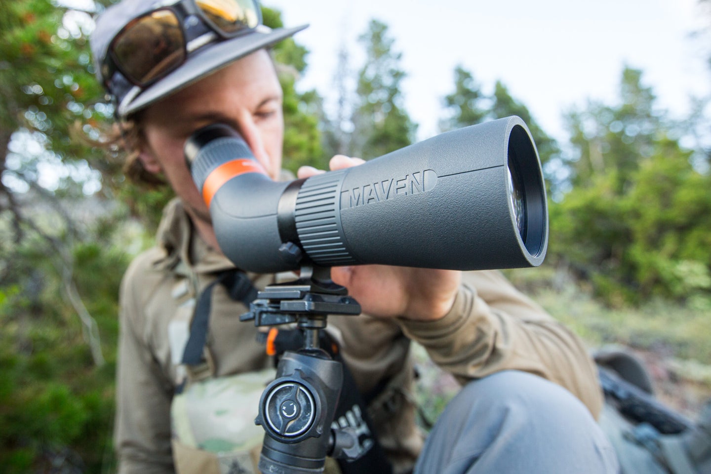 hunter looking through spotting scope