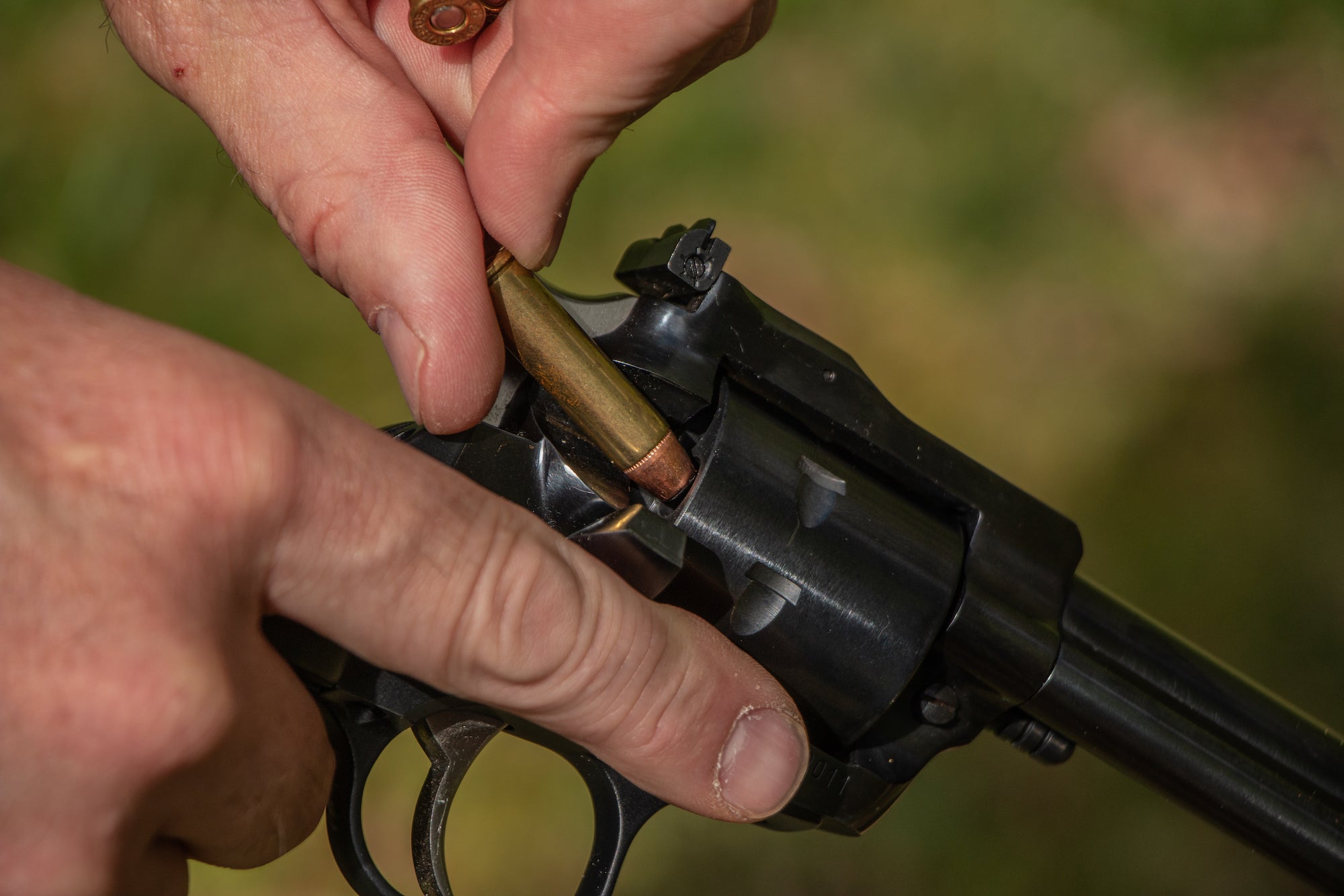 Pistols vs handguns: loading a revolver.