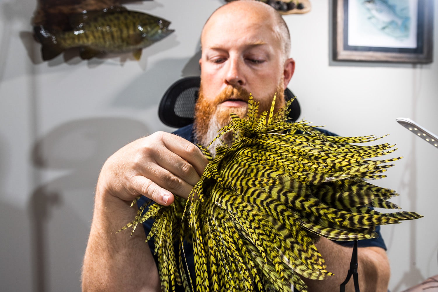 Fly-tier Brandon Bailes searches through feathers