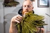 Fly-tier Brandon Bailes searches through feathers