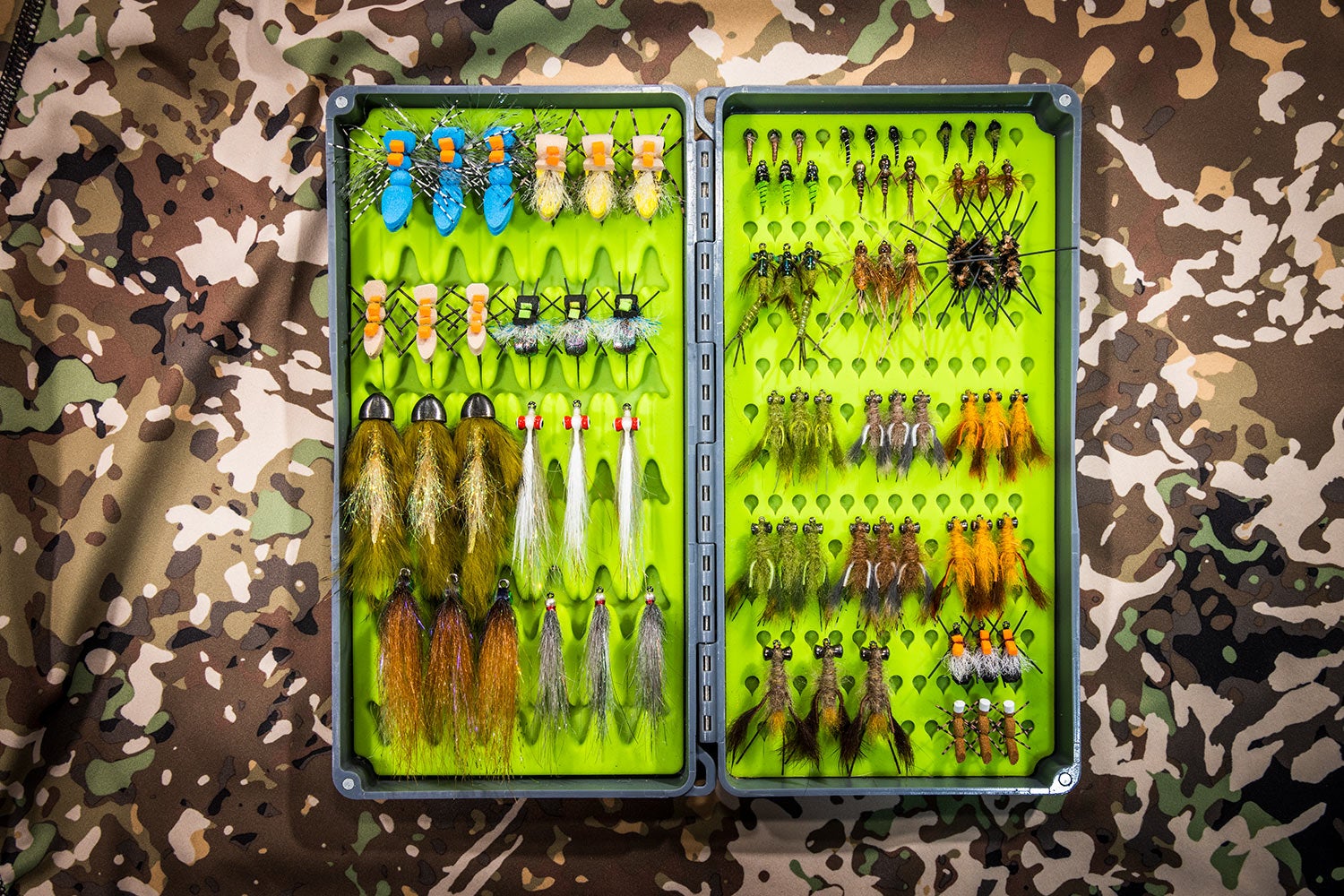 open fly box filled with many flies