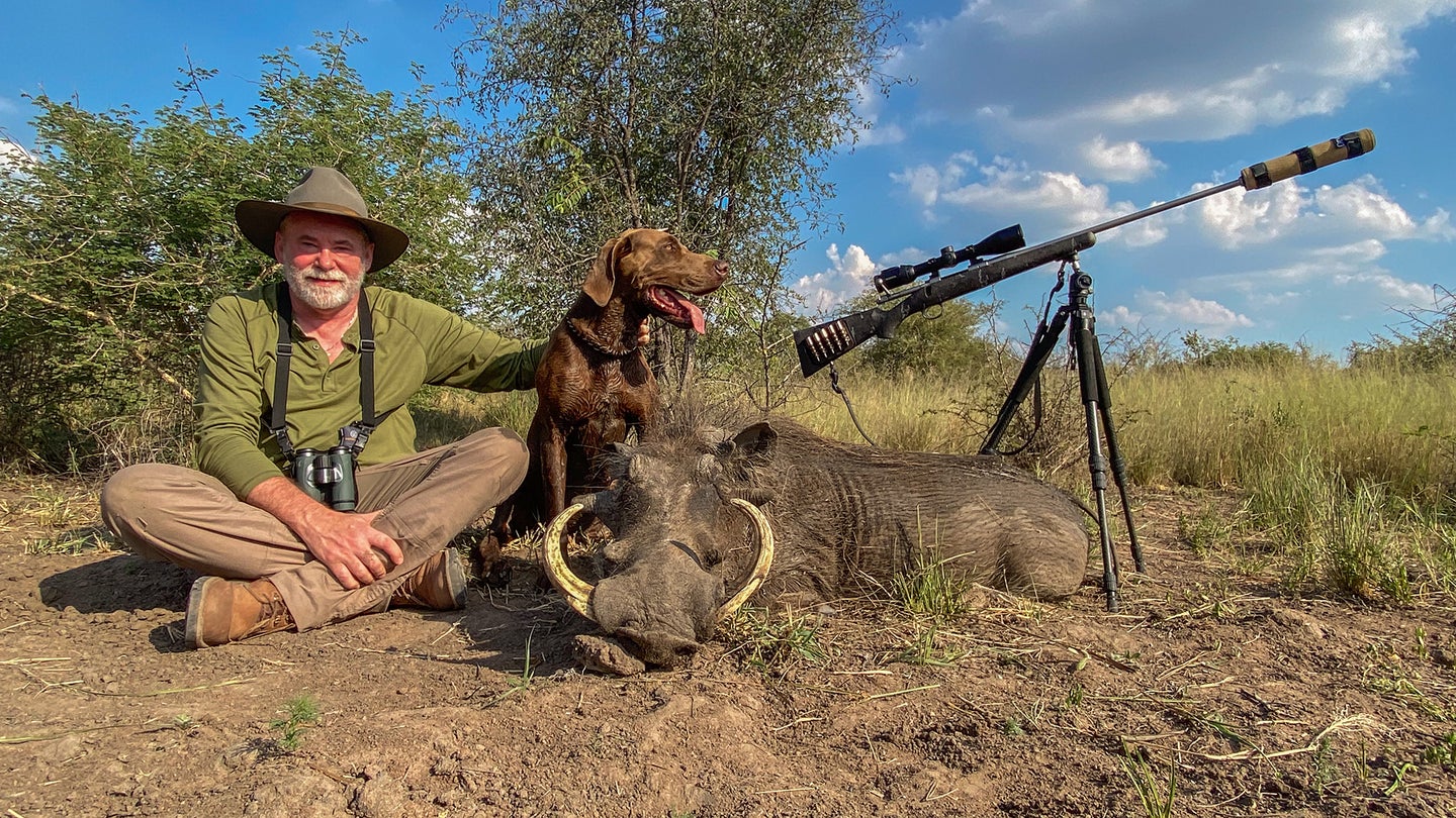hunter with warthog and dog