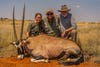 three hunters with gemsbok