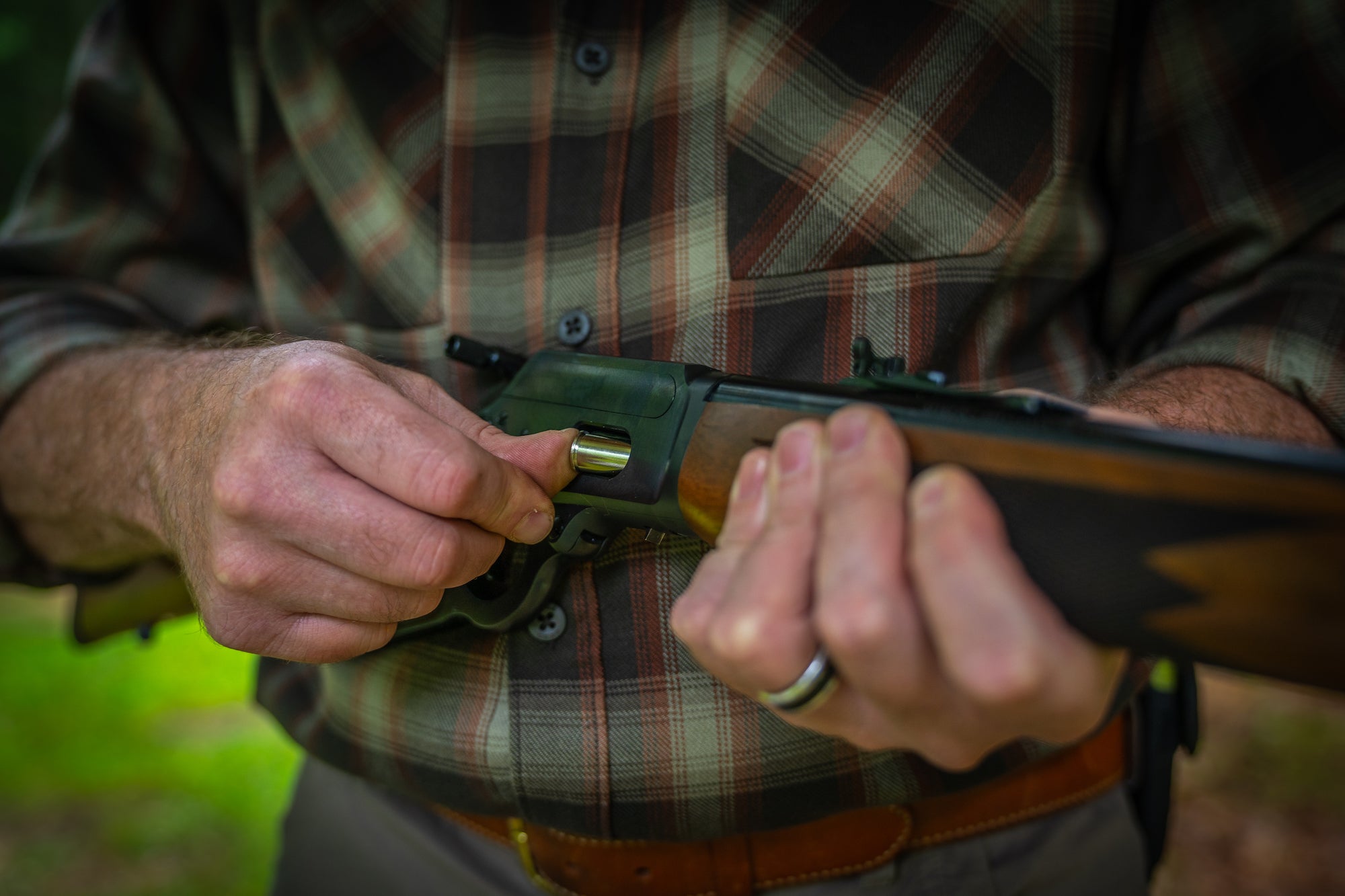 Man loading a lever-action rifle.