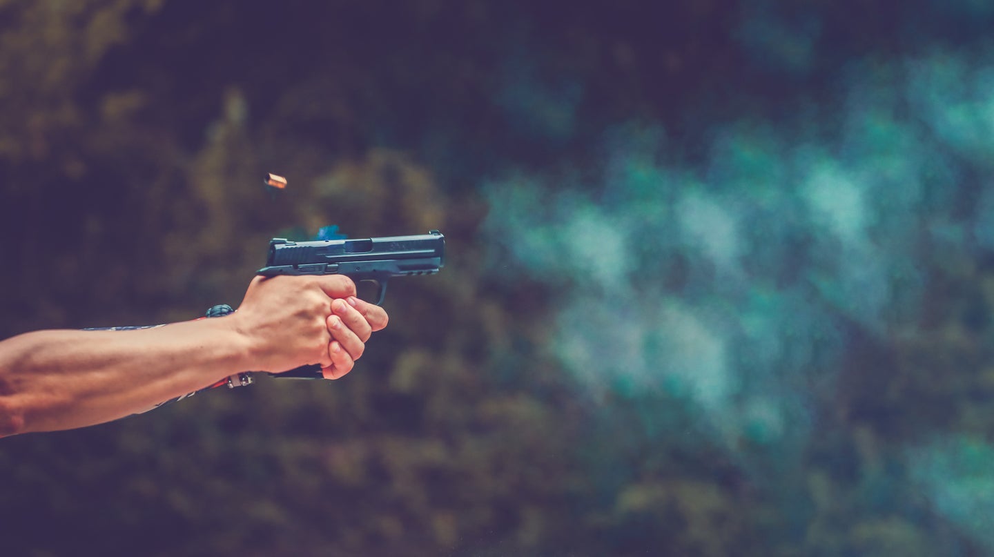 How fast does a bullet travel? Man shooting a handgun.