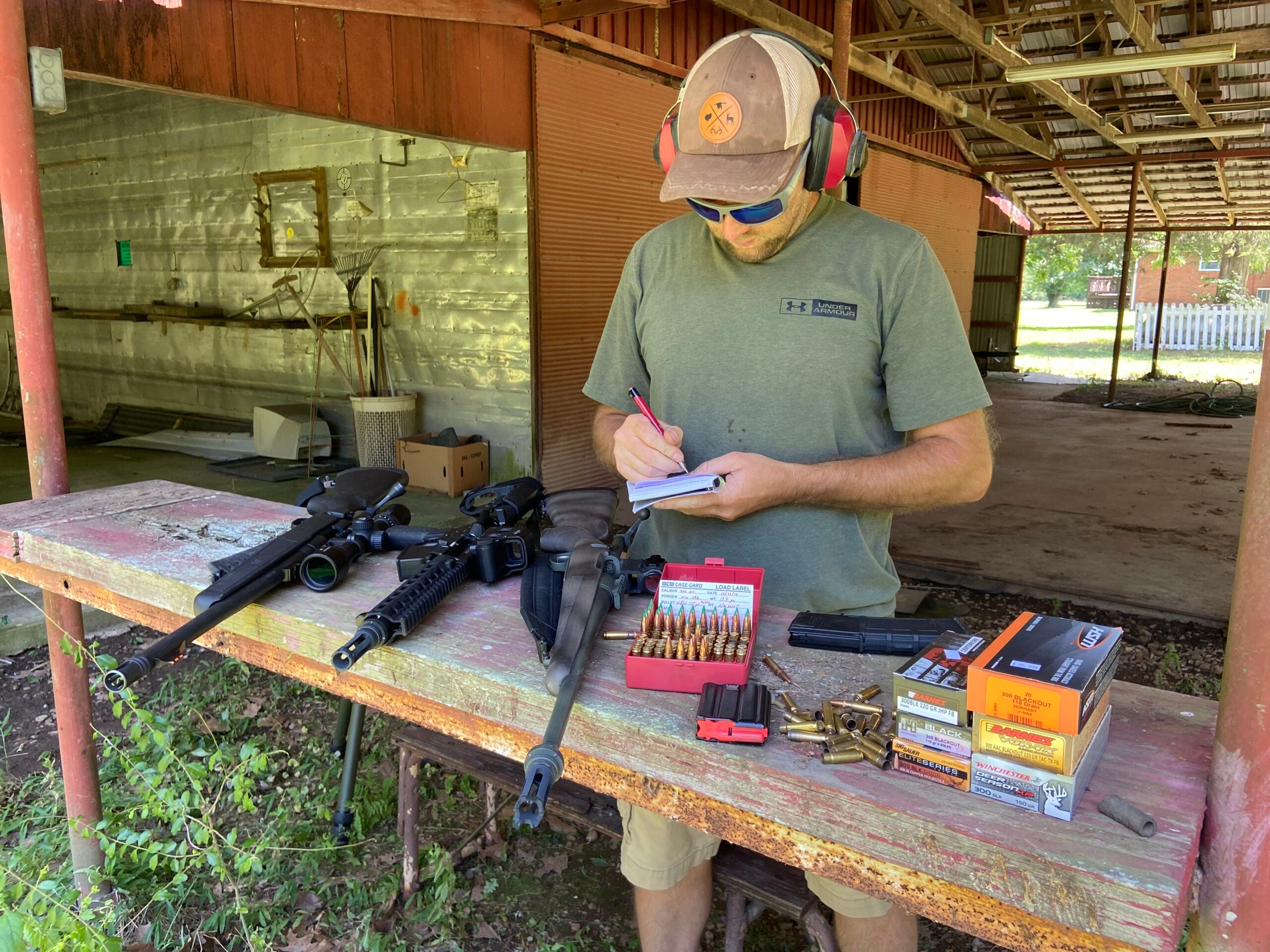 photo of the author standing at a shooting bench preparing to test 300 Blackout ammo