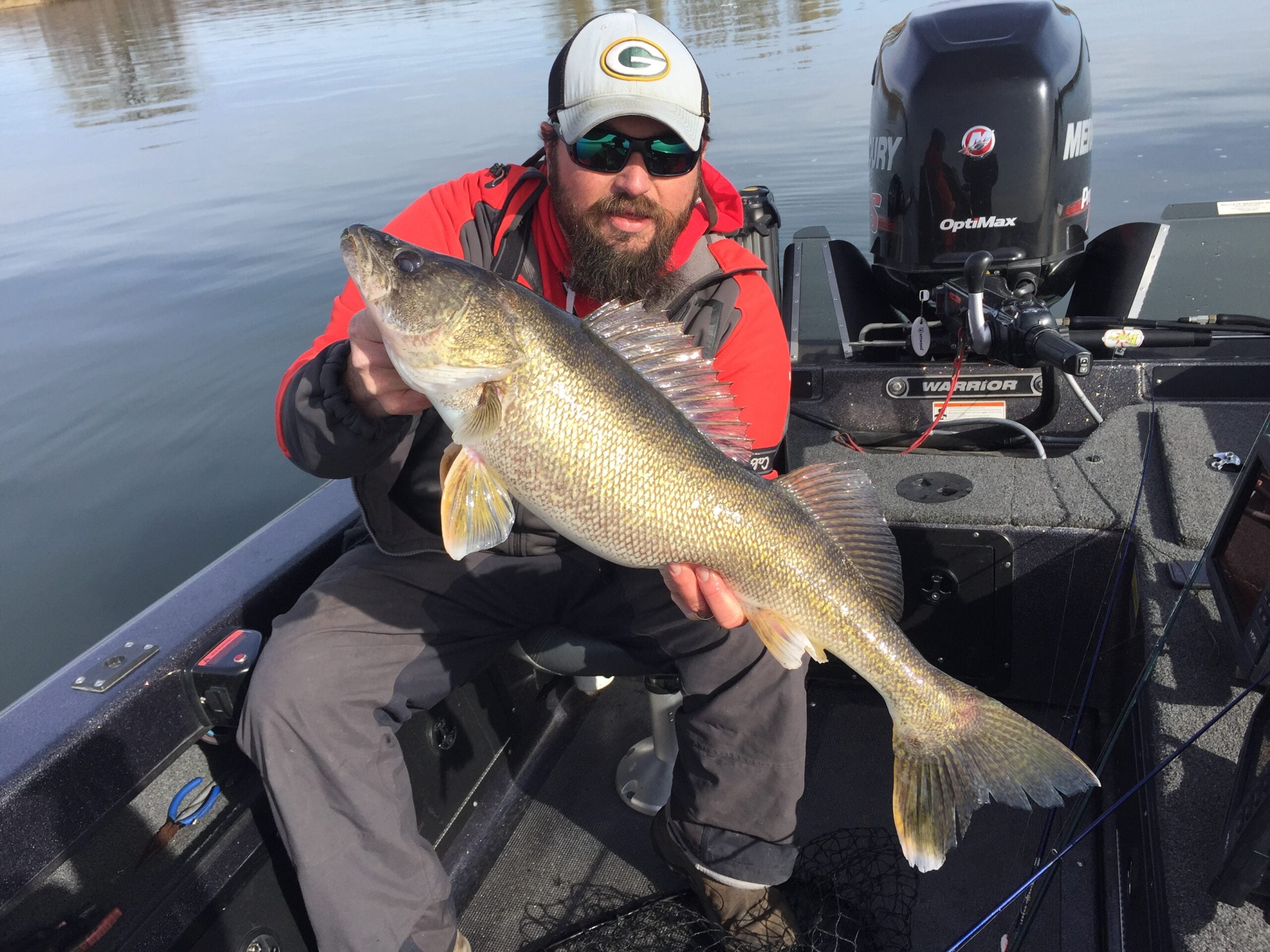 An angler shows off a trophy walleye he caught
