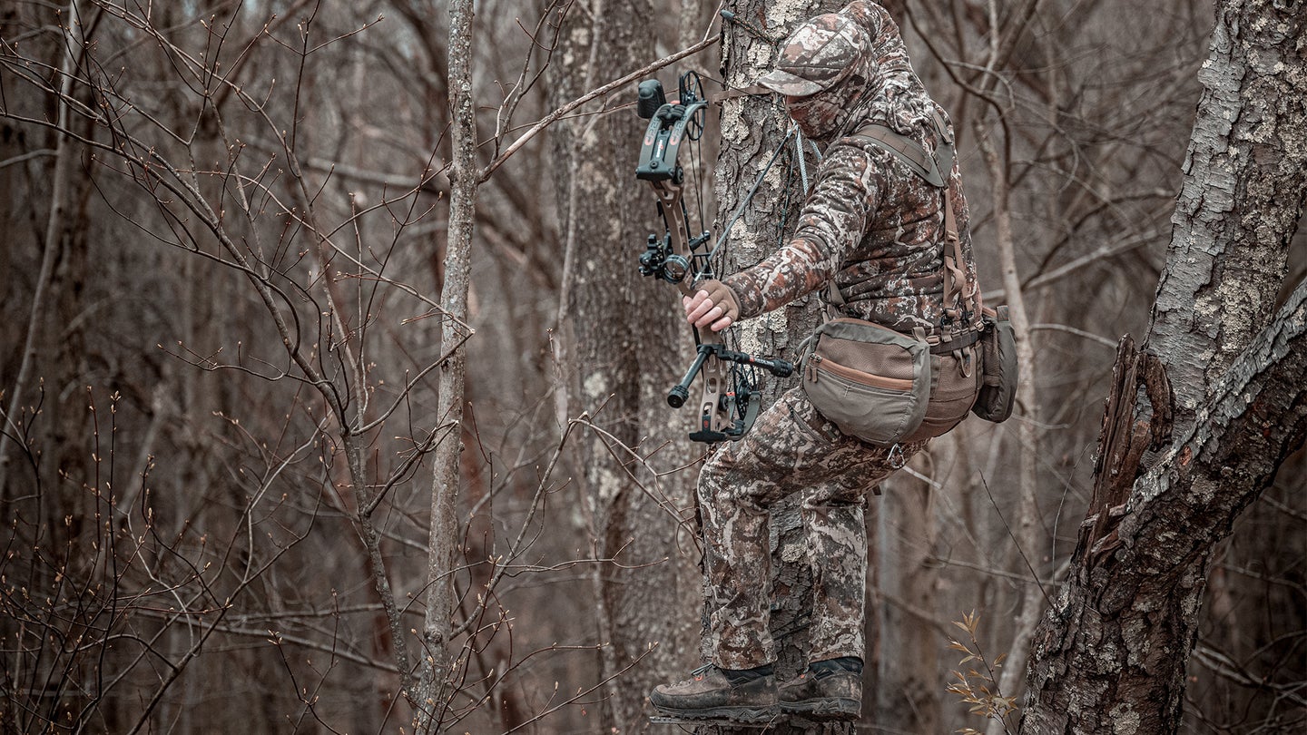 photo of a man bowhunting from a tree saddle