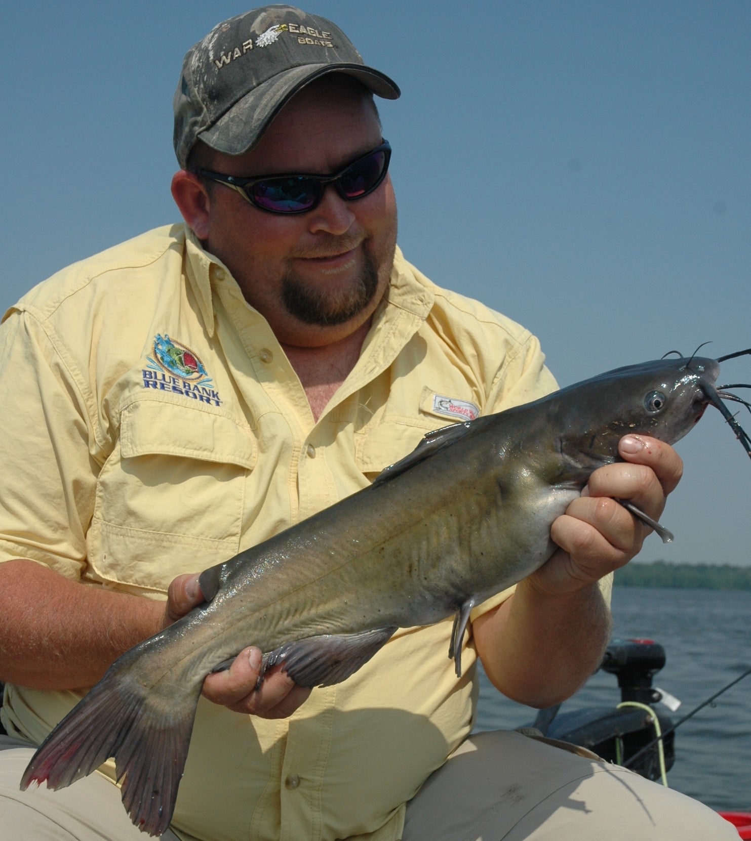 an angler holding a channel catfish