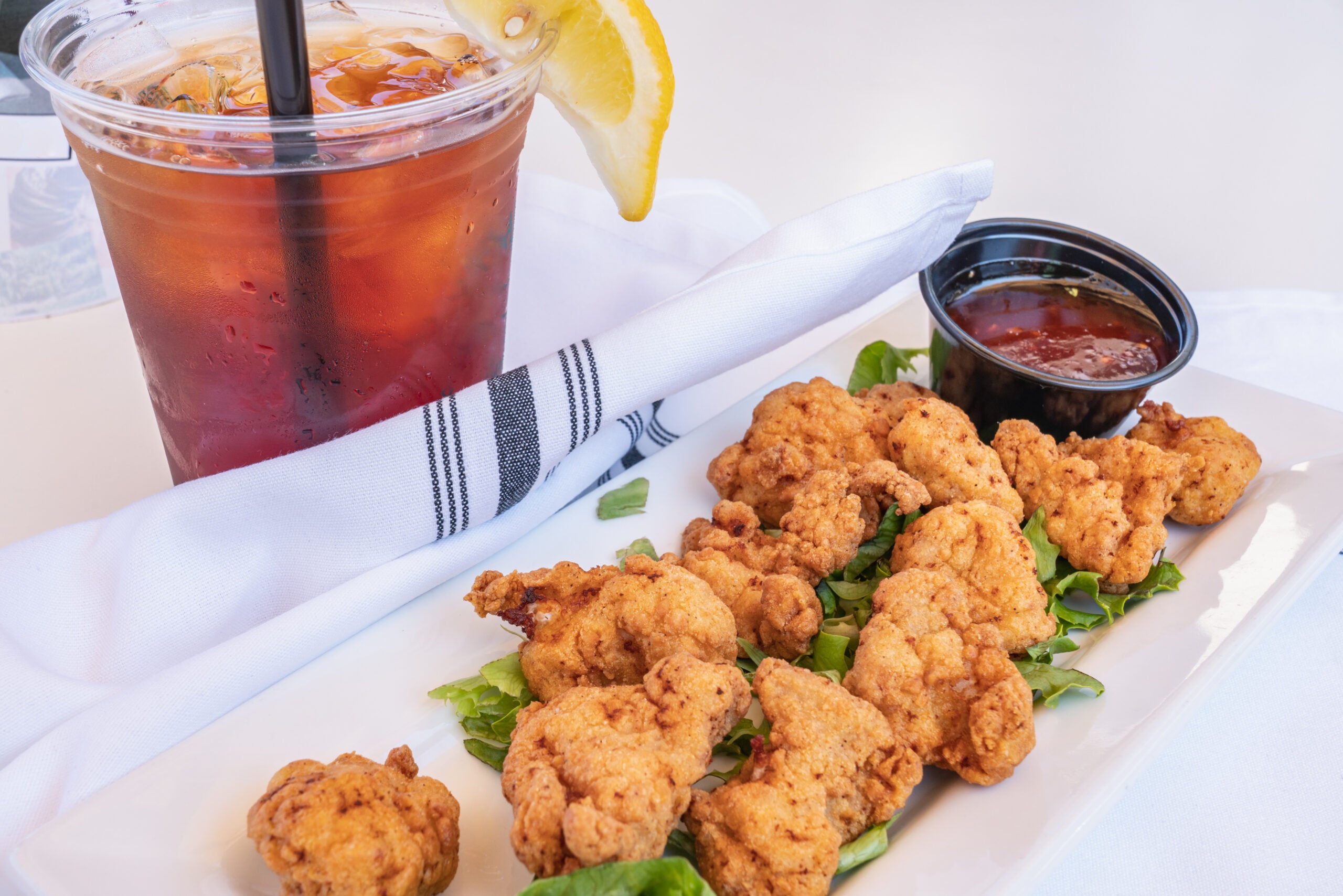 photo of fried alligator meat with iced tea