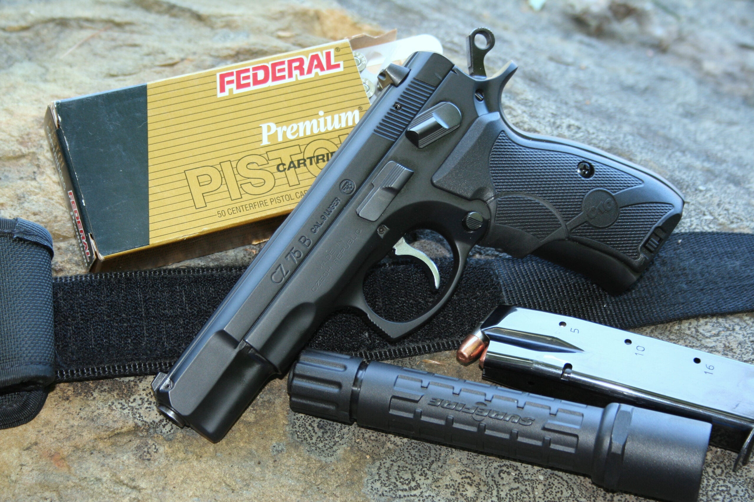 photo of a CZ-75 pistol with ammo, magazine, and flashlight