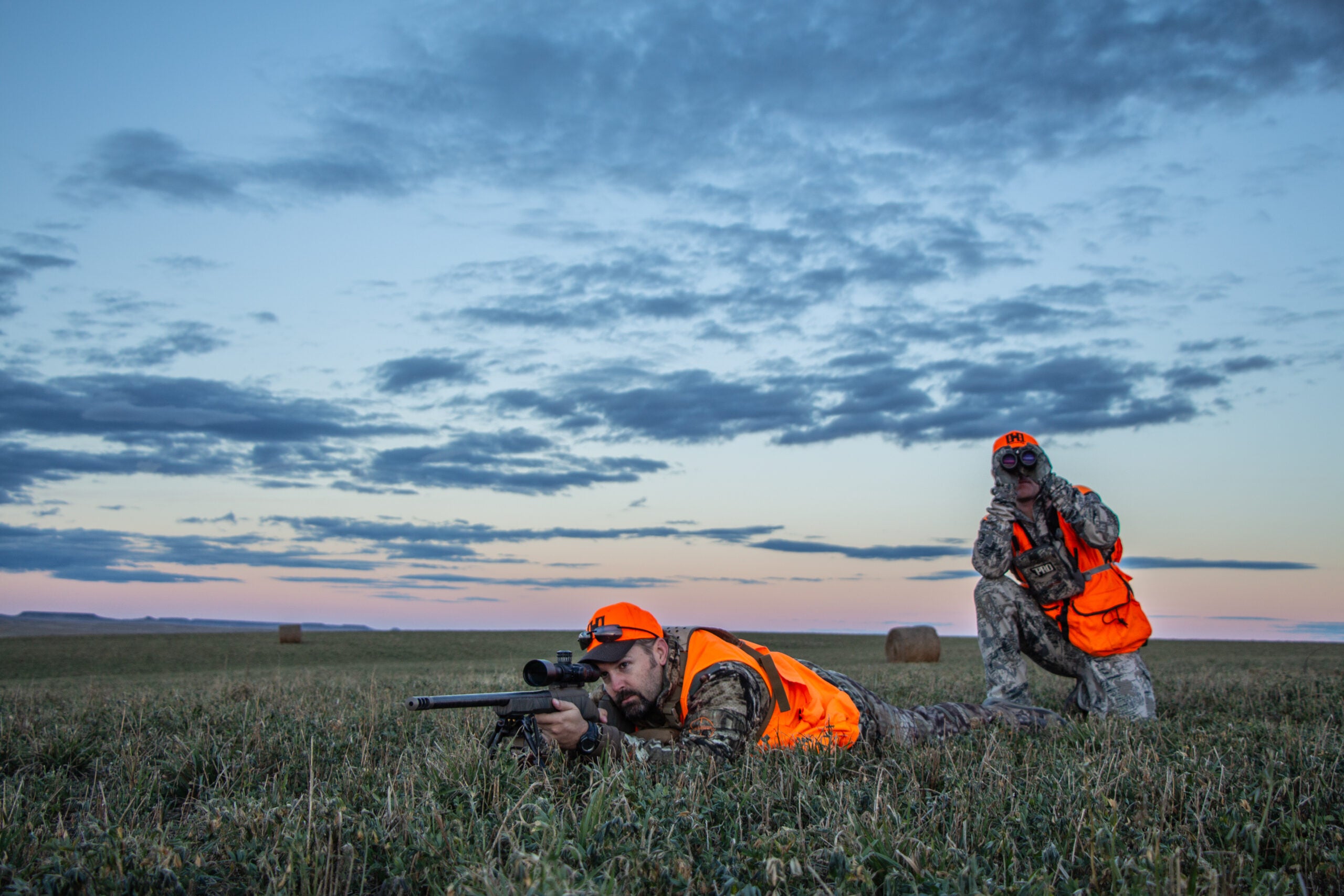 photo of hunter taking a long-range shot with a ffp riflescope