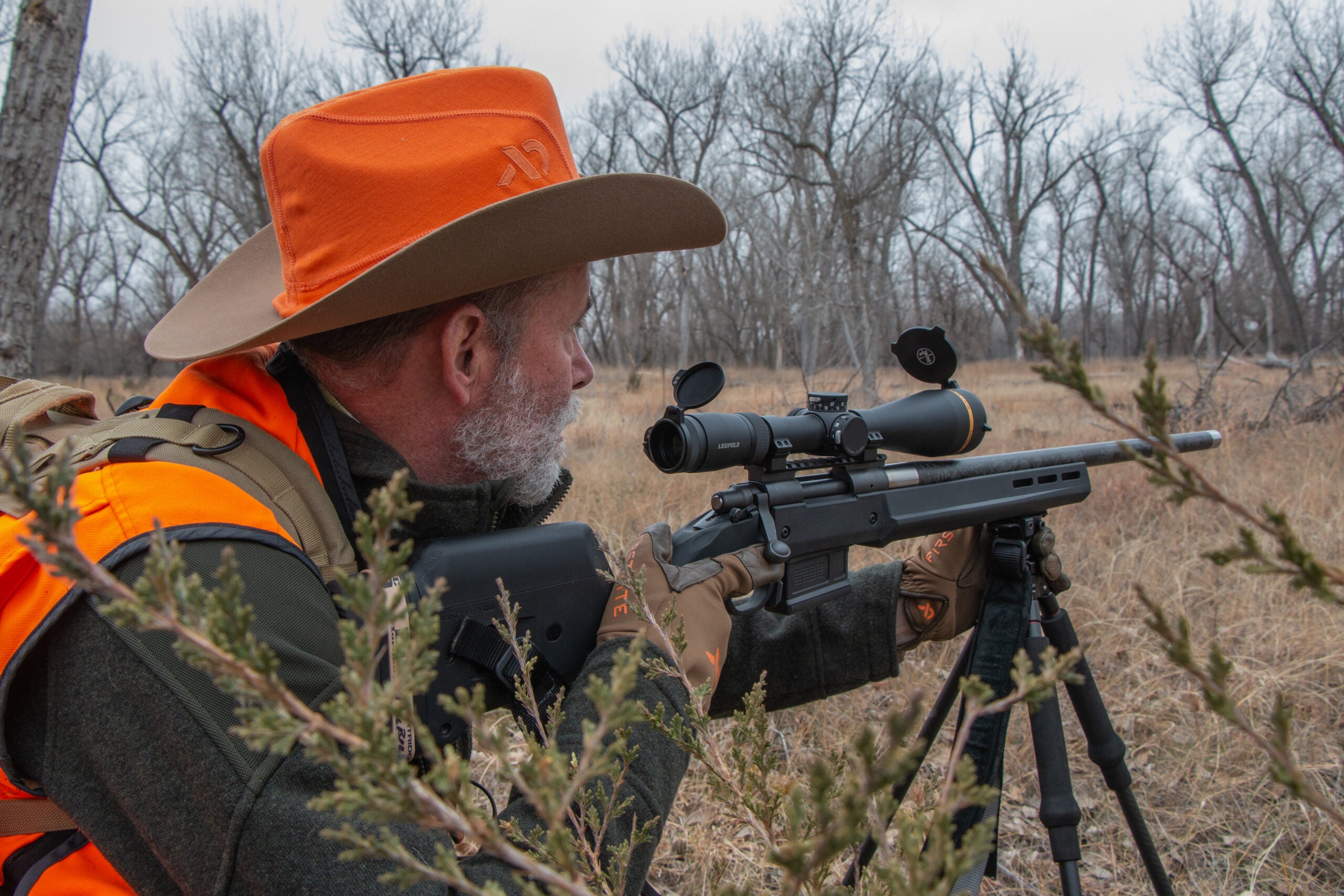 photo of the author hunting with a rifle and sfp scope