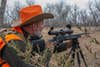 photo of the author hunting with a rifle and sfp scope
