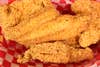 golden brown fried catfish fillets in a basket