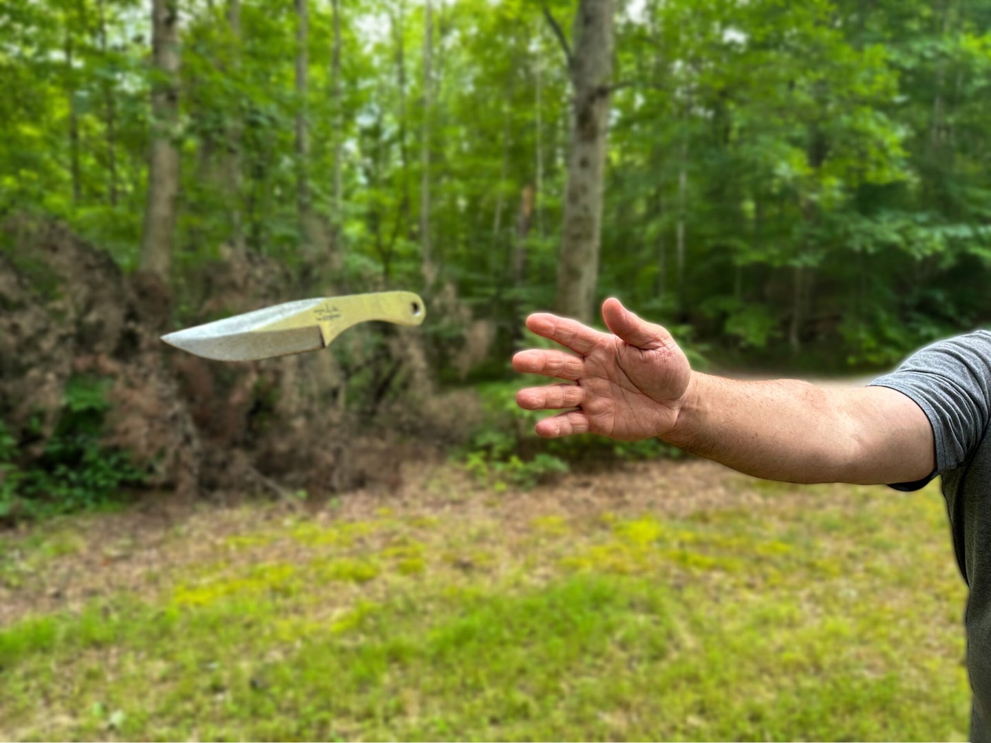 an expert shows how to knife throw.