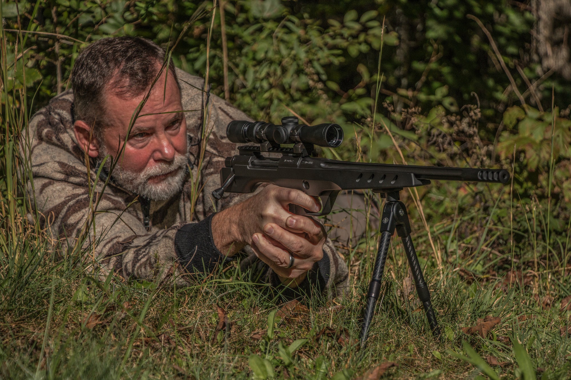 photo of hunter shooting a scoped bolt-action pistol