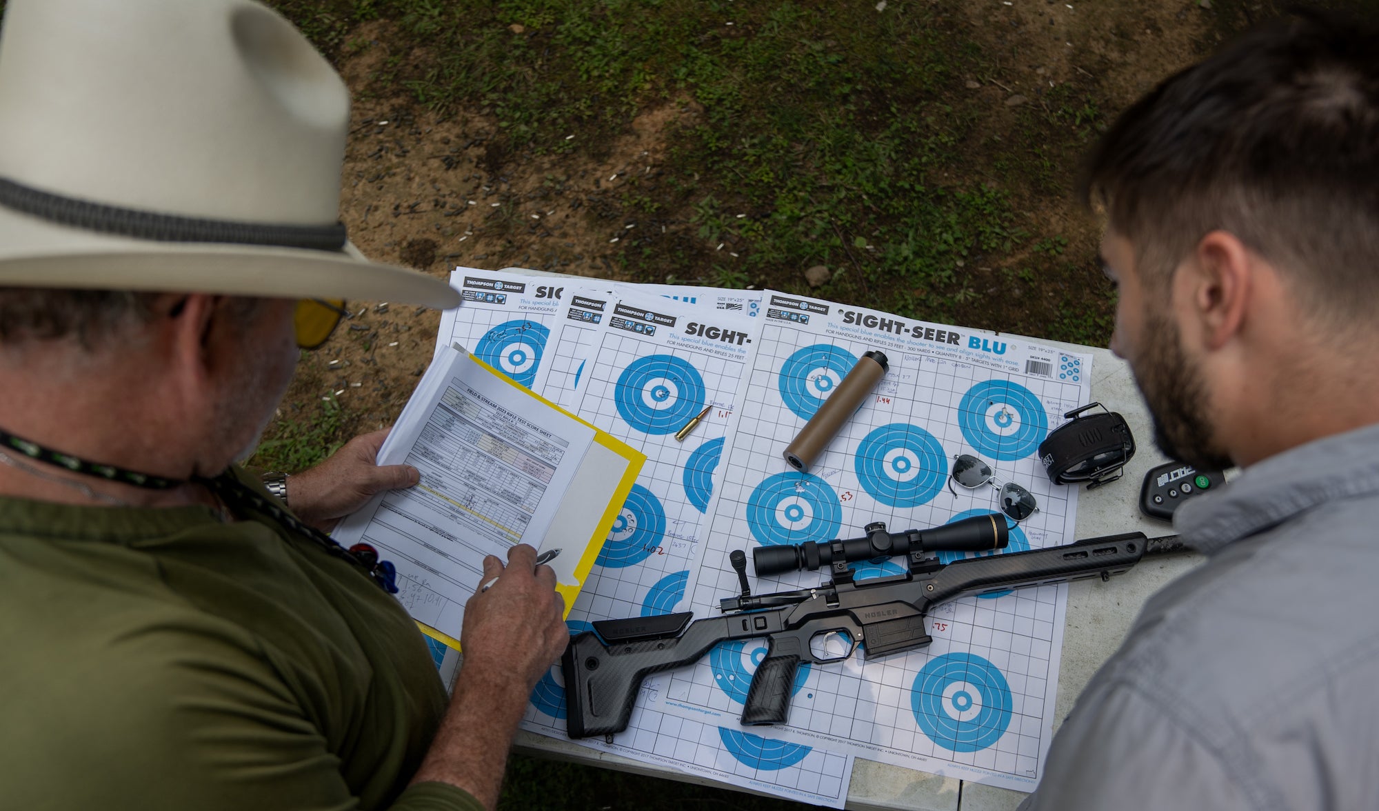 evaluators go over the results of the range-shooting test