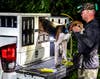 hunter brings coonhound out of truck crate