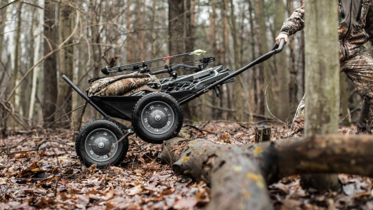 Hunter pulling Hawk Crawler Deer Cart through woods