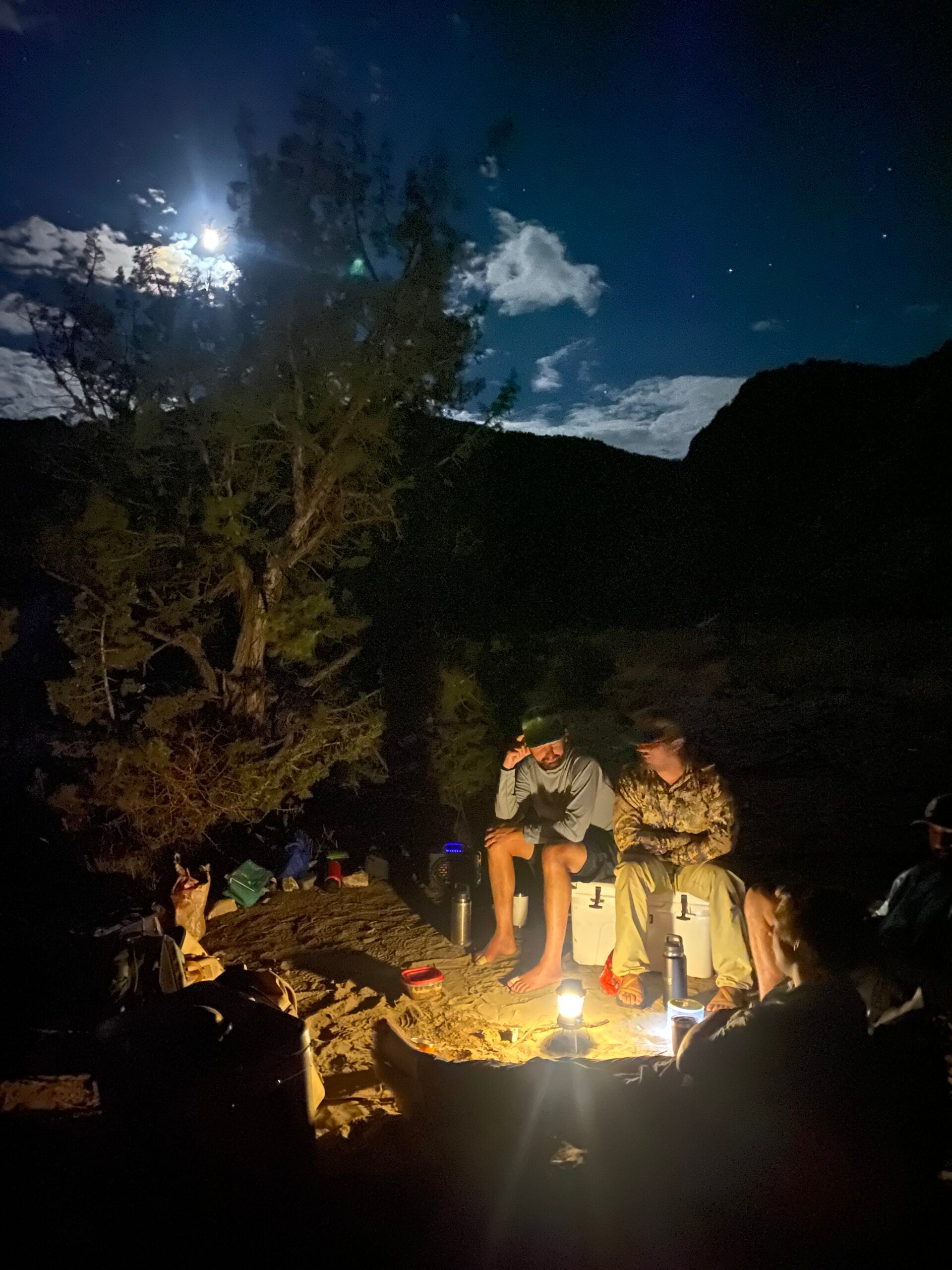 Hunters sitting around a campfire at night