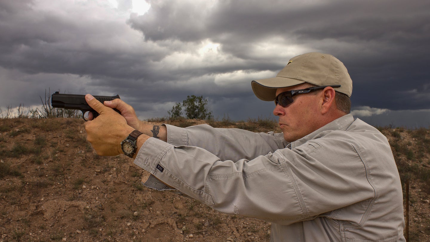 photo of a man shooting a pistol