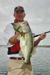 an angler with a big bass caught from Lake Amistad