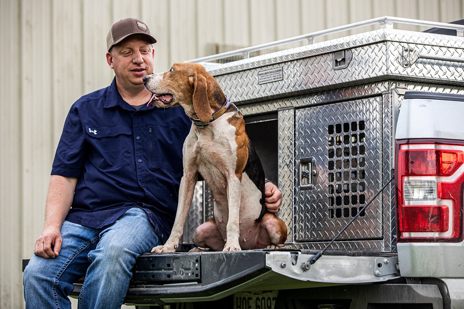 Greg Maynard poses with Molly on truck tailgate