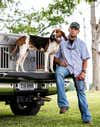 Trey Hewitt and hound Debot pose on truck tailgate