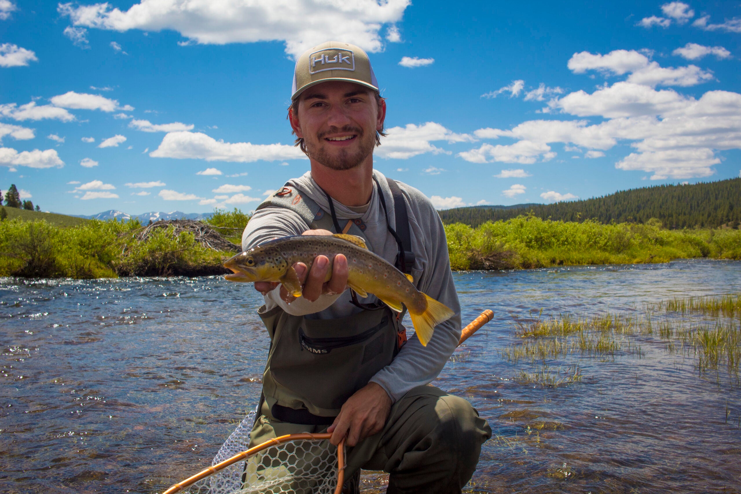 The author's friend with a brown trout caught in a high country stream at 11,000 feet.