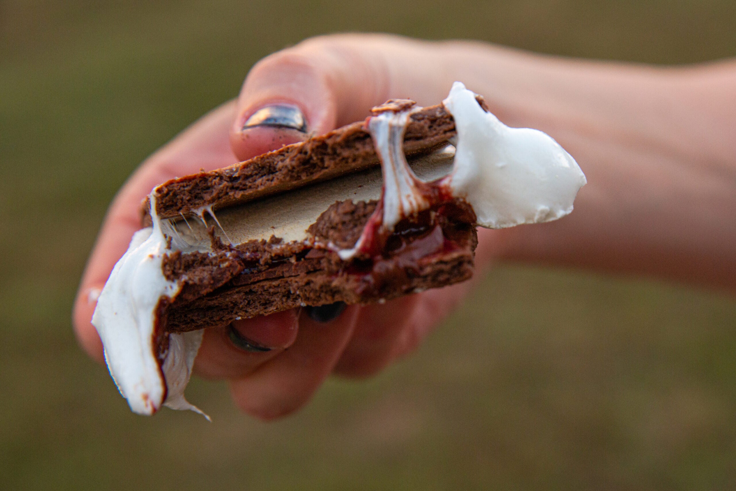 a s'more made with chocolate graham crackers is a great camping food idea for dessert