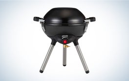 The Coleman 4-in-1 portable grill on a black and white gradient background.