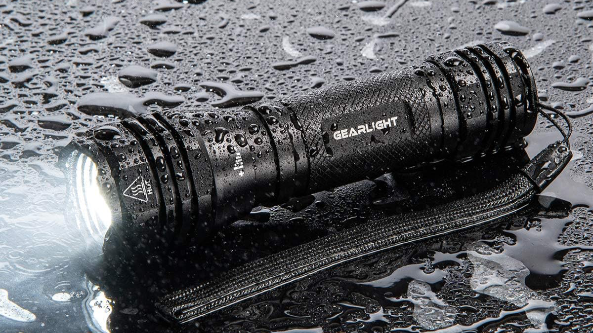 GearLight S1050 Flashlight laying on pavement in the rain