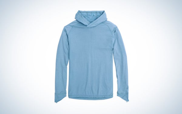 A blue Free Fly Elevate hoodie on a black and white gradient background.