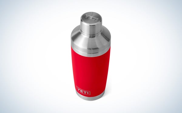 The silver and red Yeti Rambler Cocktail Shaker on a grey and white gradient background.