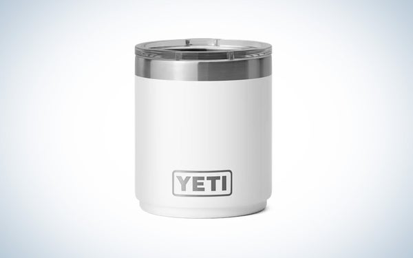 A white yeti stackable cup with a stainless rim on a white and grey gradient background.
