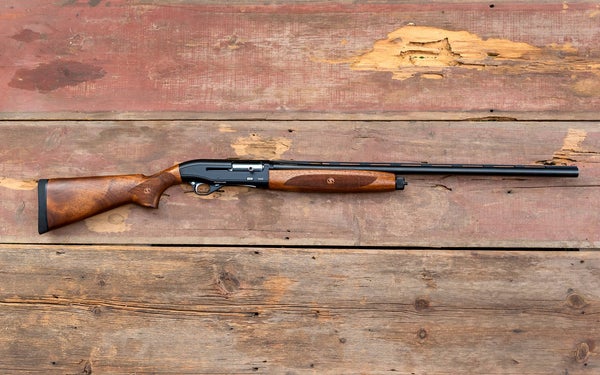 The new Steven 560 shotgun lying on old barn boards.