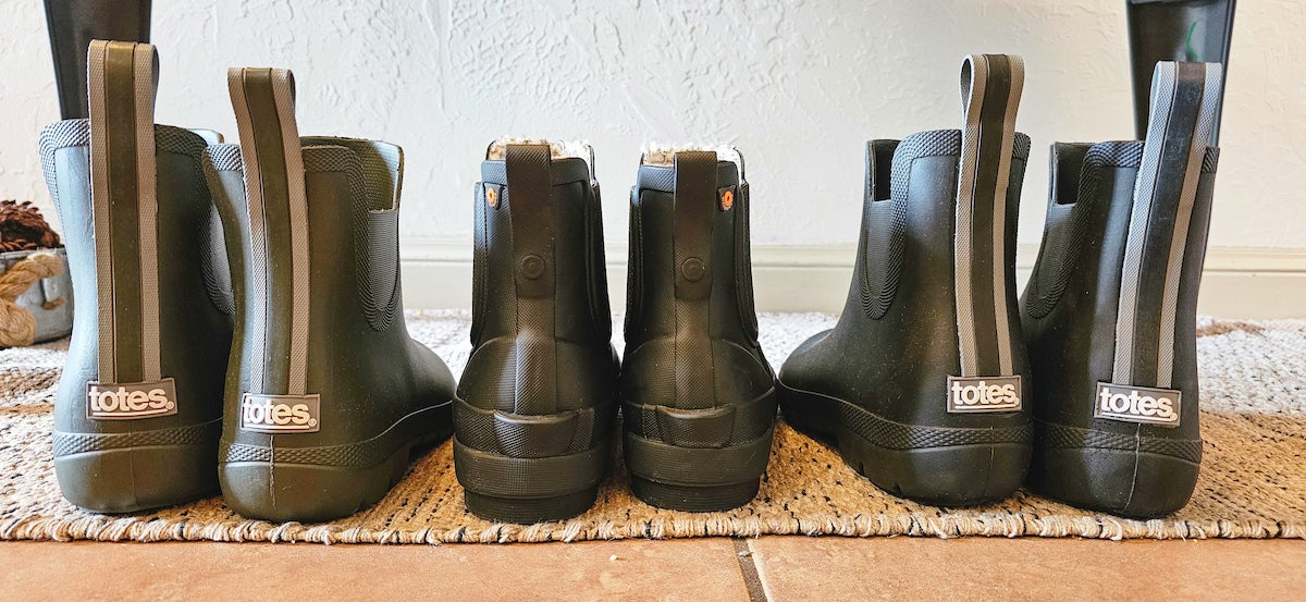 Totes and Bogs rain boots for women lined up on floor
