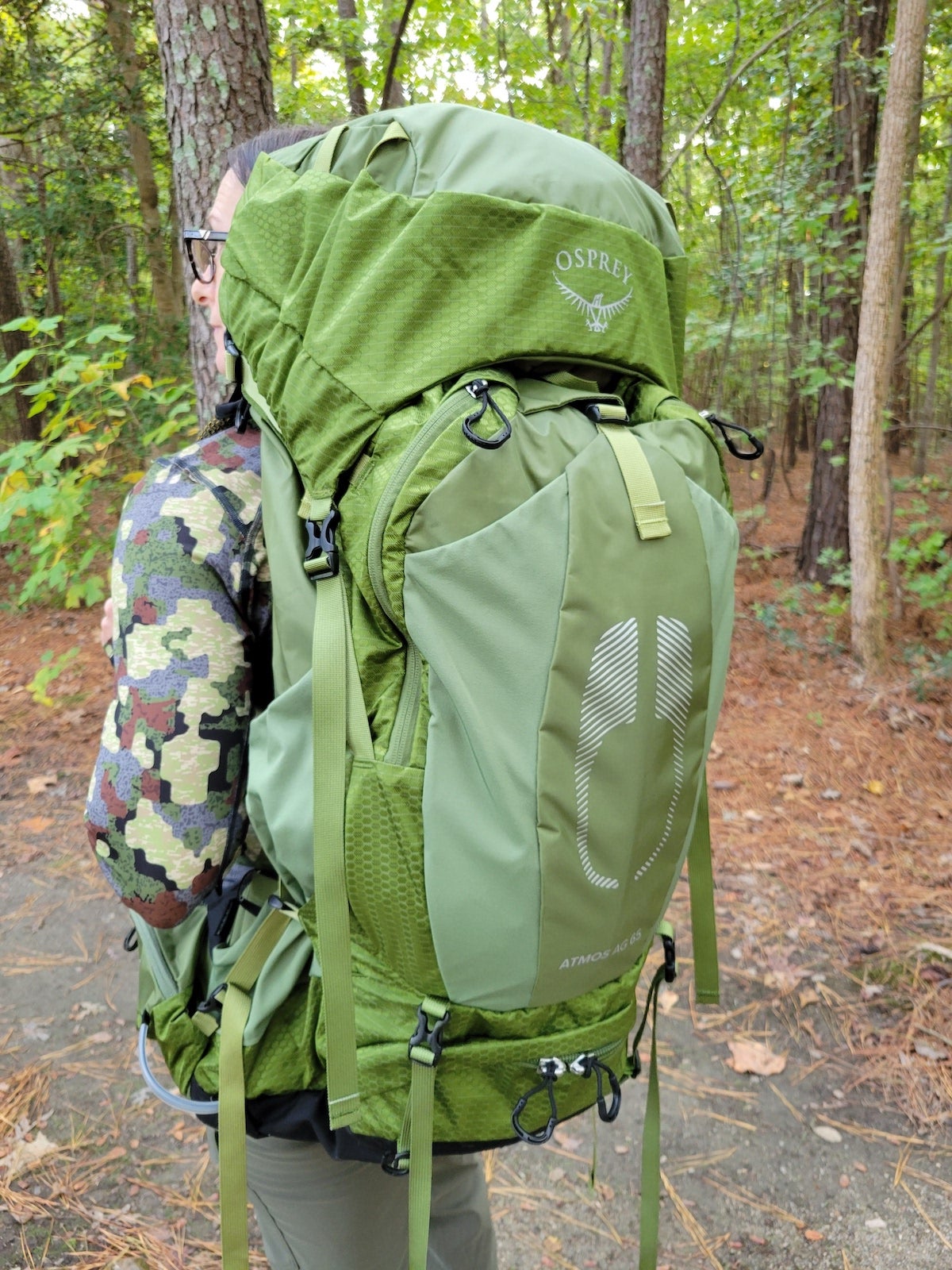 Female hiker wearing Osprey Atmos AG 35 backpack