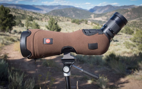 Leica APO Televid spotting scope on tripod with mountains in the background