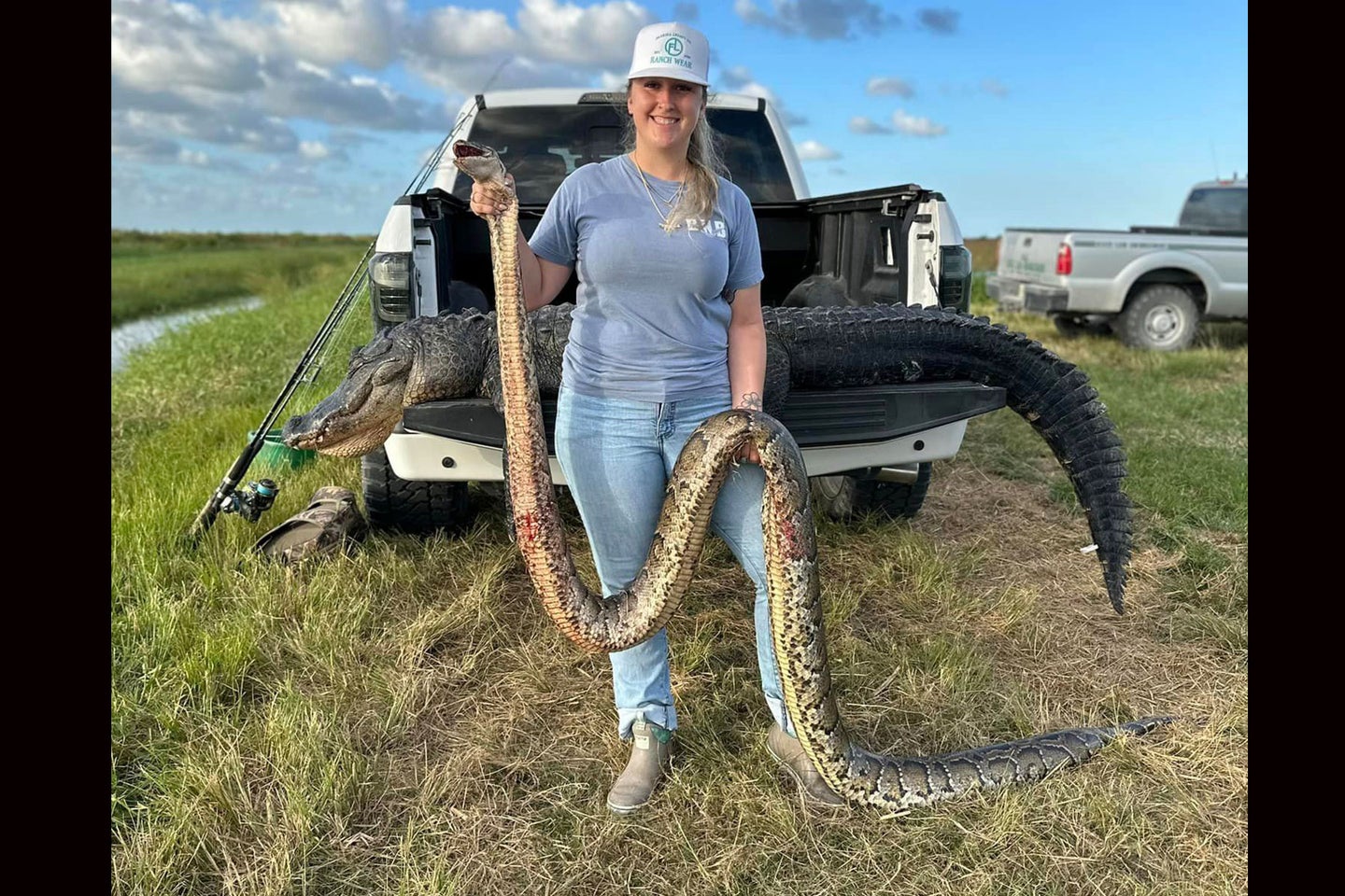 Hunter Kaylee Stillwagon posed with the giant snake in front of a gator tagged the same day. 