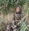 Female duck hunter wearing DSG Kylie Jacket in marsh