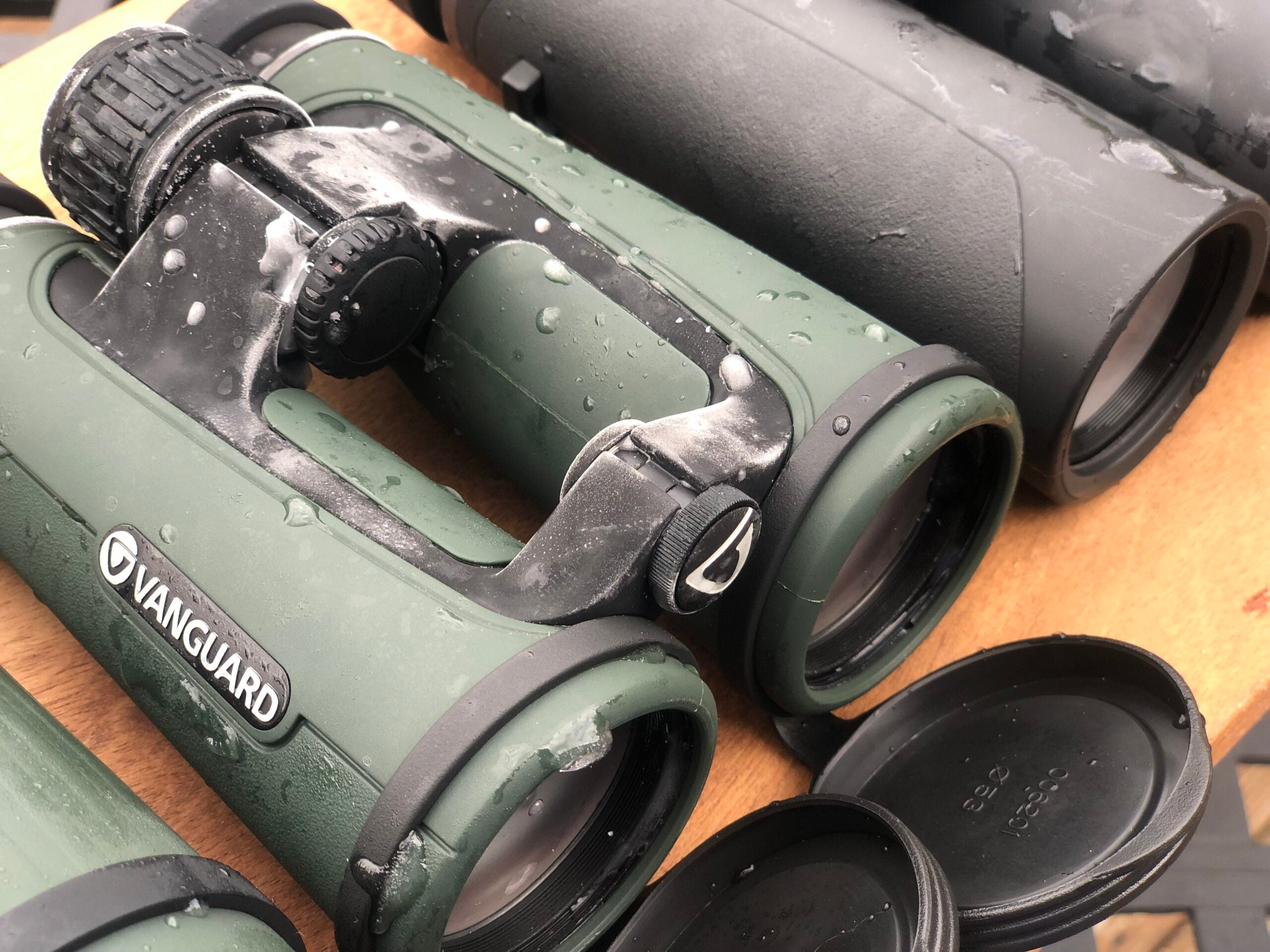 A frozen binocular sitting on a table with other binoculars.