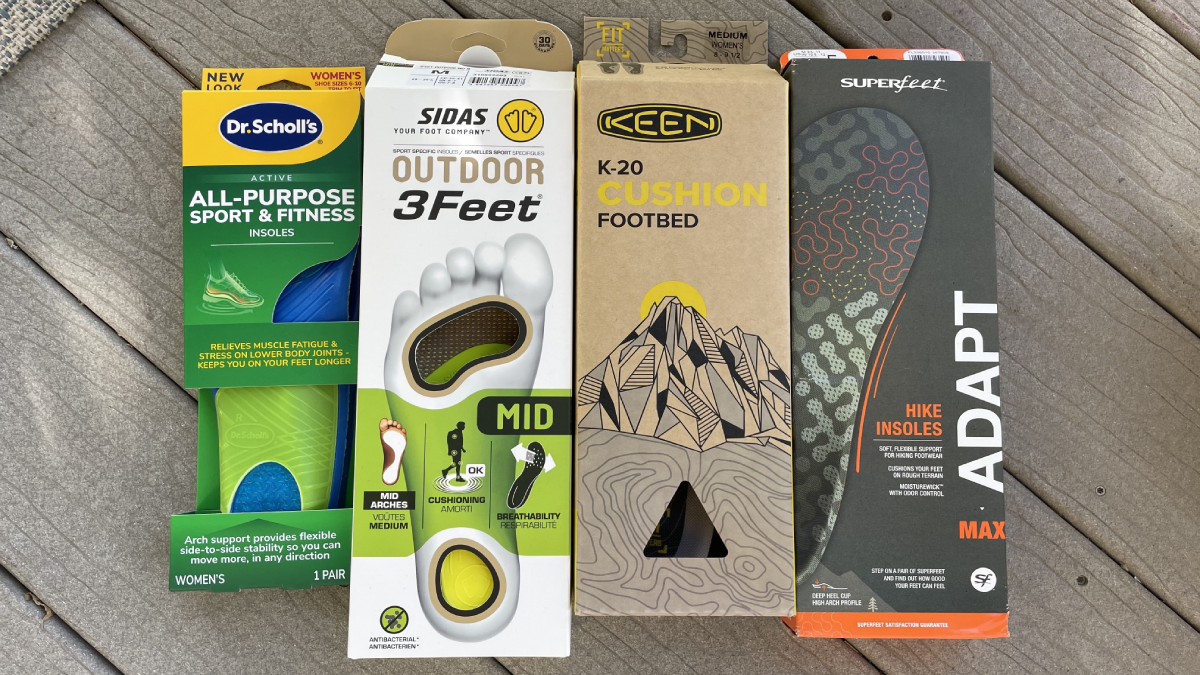 Packs of insoles for hiking lined up: Dr. Scholl's, Sidas, Keen, Superfeet