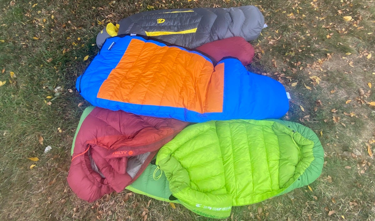 Four 0-degree sleeping bags spread out on grass