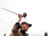 A man wearing a brown hat and vest casts a fly fishing rod in Montana.