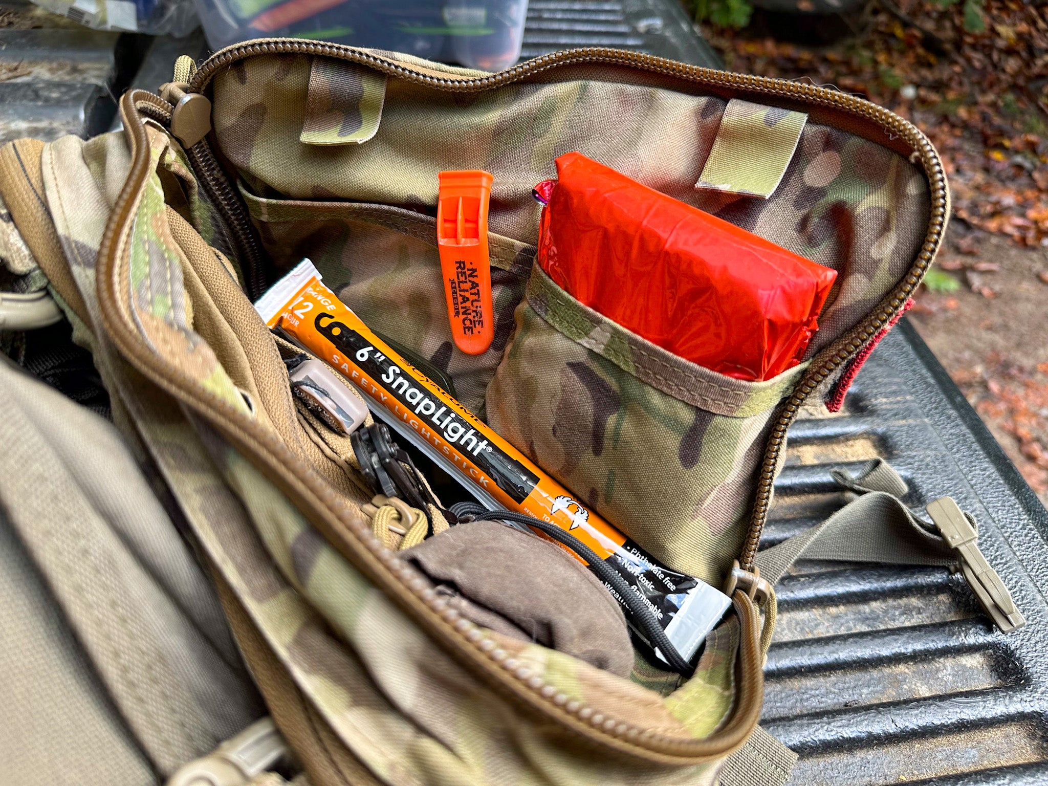 A survival pack with various items that can be used as ways to signal for help in the wilderness.