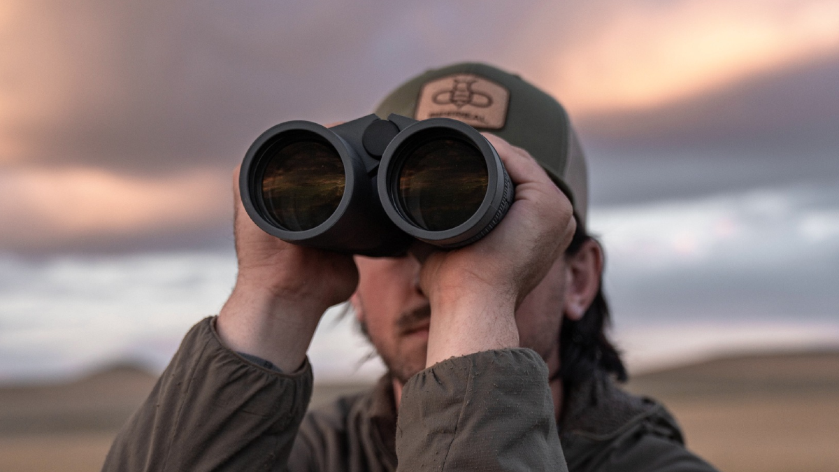 Hunter looking through Leupold binoculars